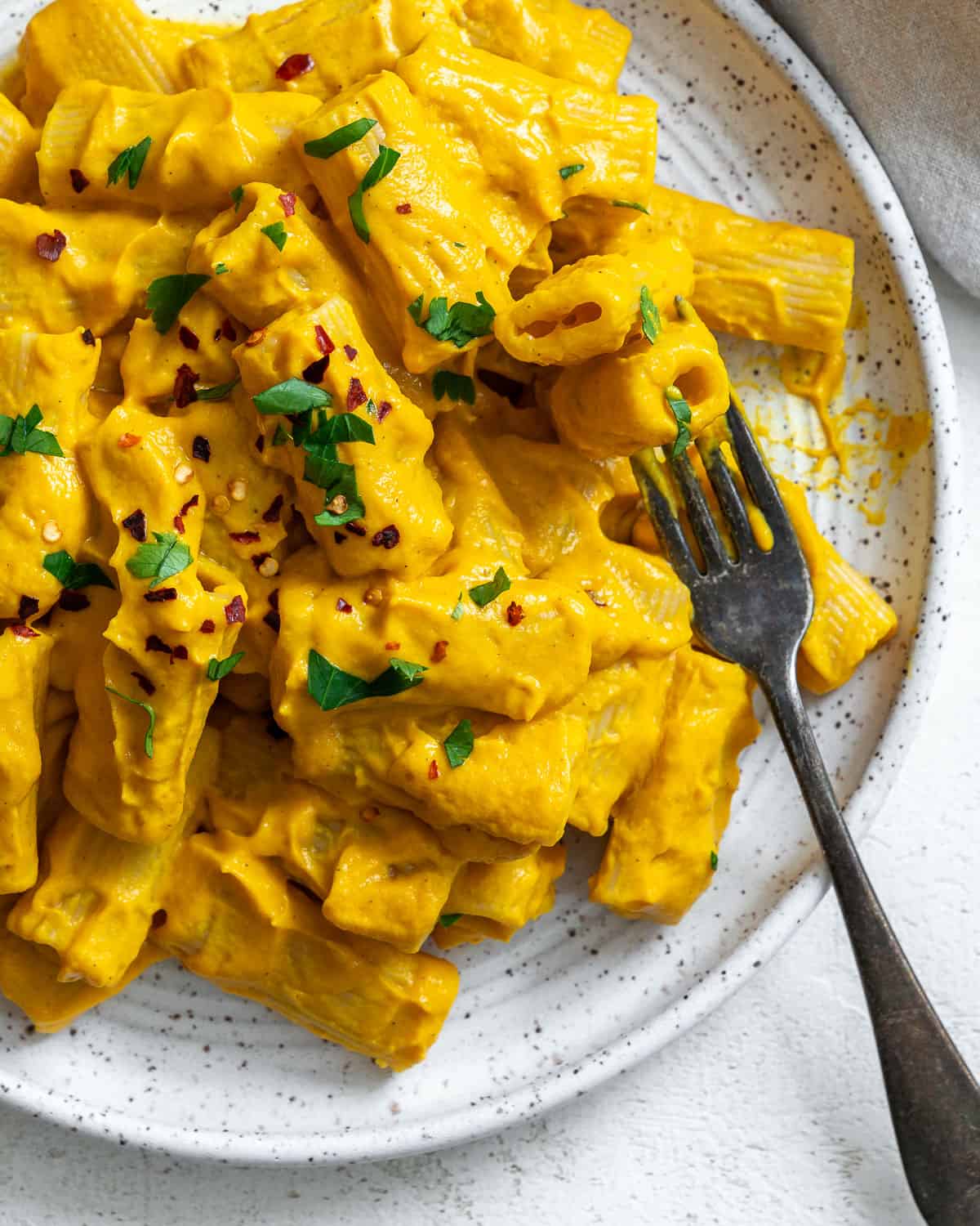 completed and plated Easy Carrot Pasta Sauce against a white surface