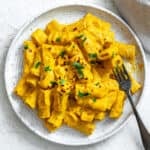 completed and plated Easy Carrot Pasta Sauce against a white surface