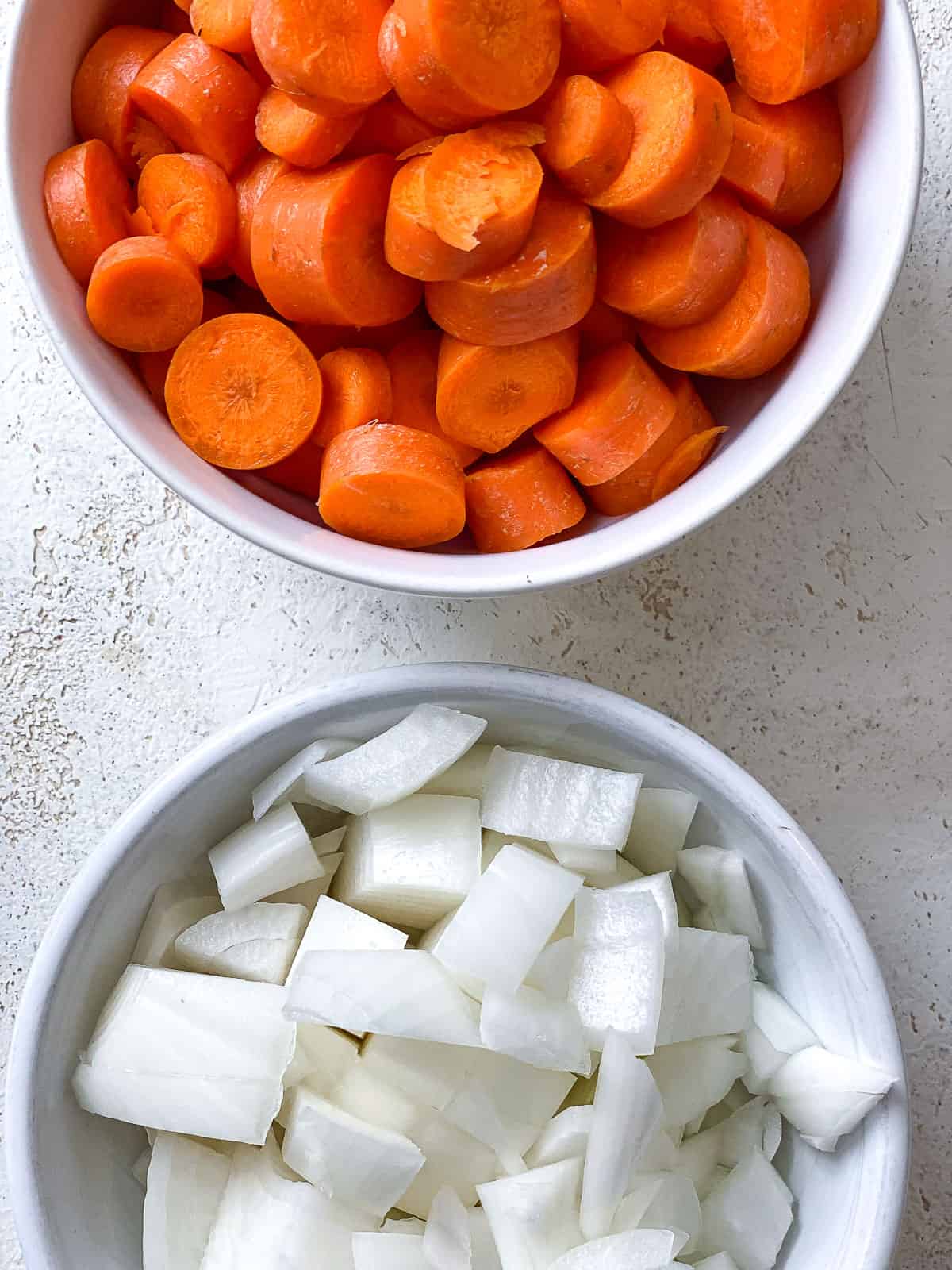 ingredients for Easy Carrot Pasta Sauce measured out a،nst a white surface