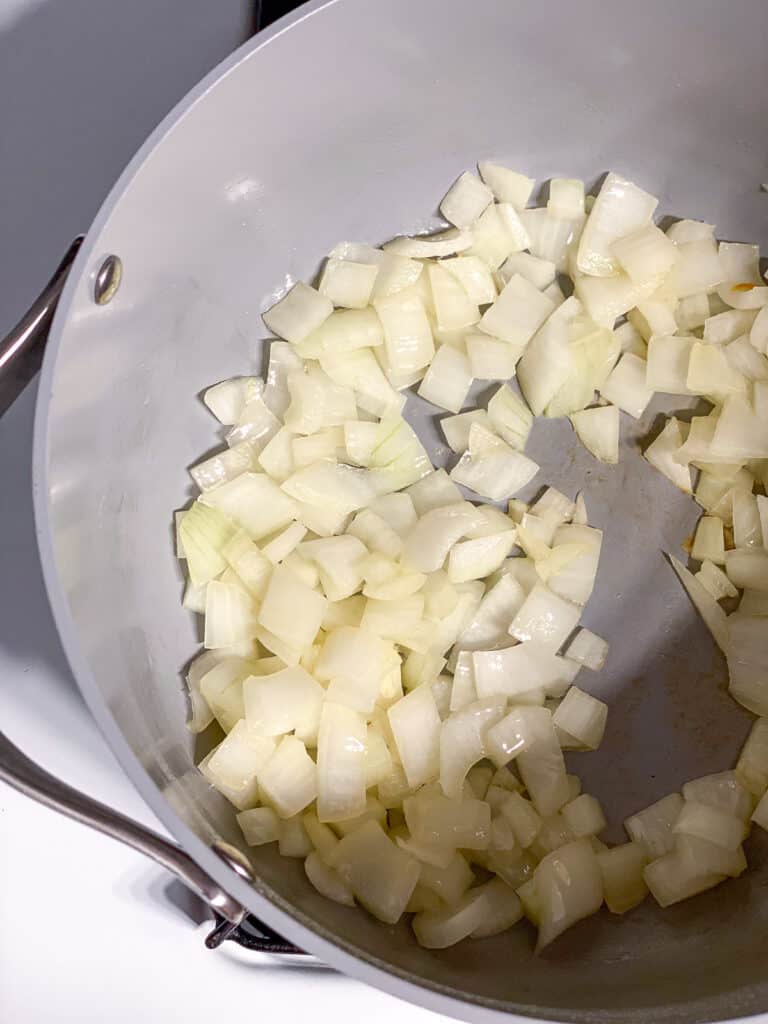 process shot of onions cooking in pan