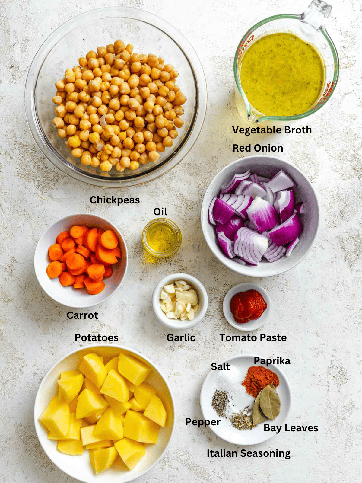 Ingredients for Easy Chickpea Stew measured out on a white surface. 