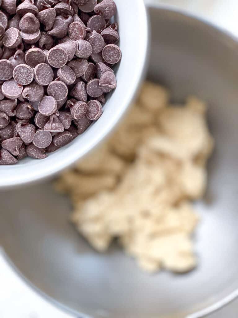 process shot of adding dairy free chocolate chips to mixing bowl