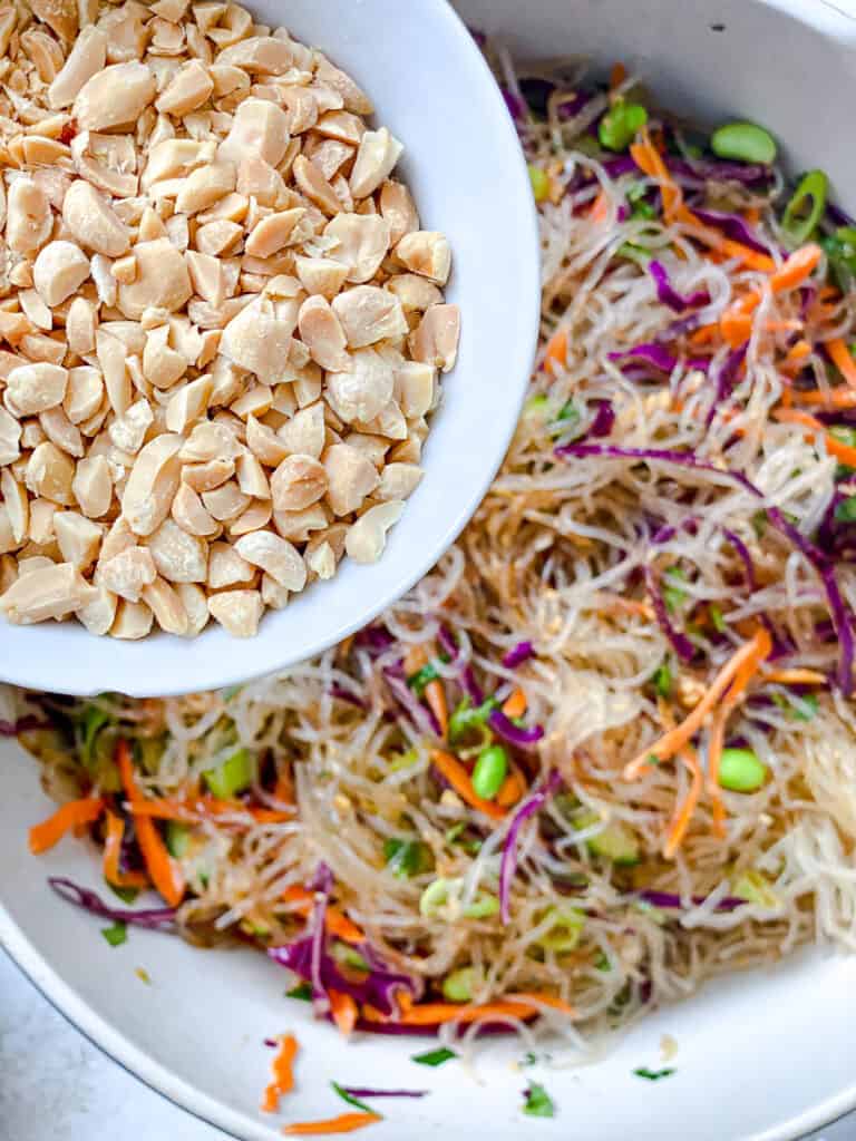 process shot of adding toppings to Thai Peanut Noodle Salad [Glass Noodle Salad]