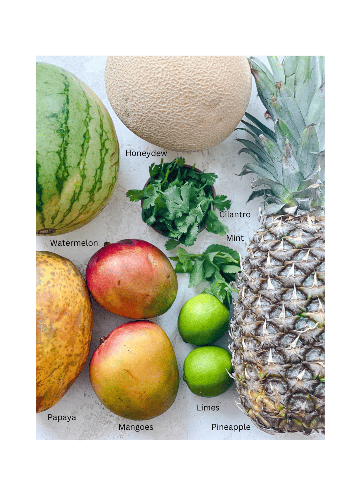 ingredients for Mexican Fruit Salad against a white surface