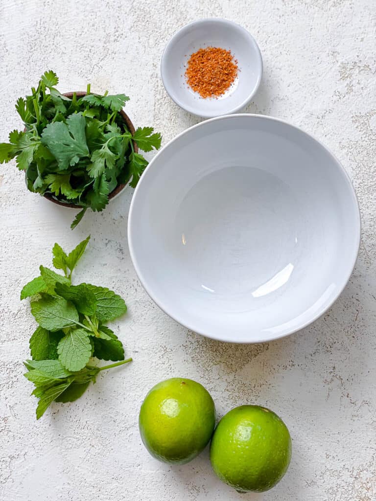 ingredients for Mexican Fruit Salad a،nst a white surface