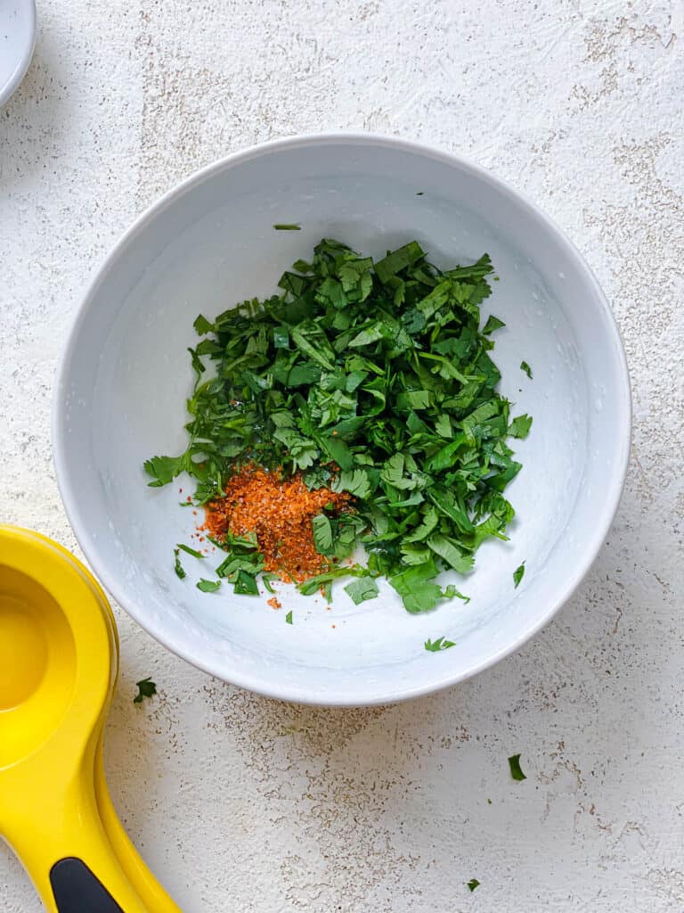 process shot of adding ingredients to a white bowl