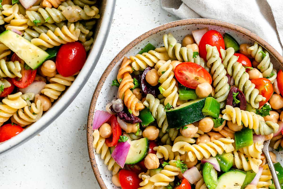 completed Mediterranean Vegan Pasta Salad plated against a white surface