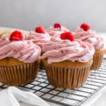 completed raspberry cupcakes on wire rack