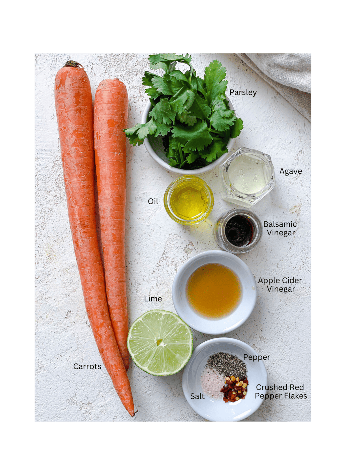 ingredients for Raw Carrot Salad measured out against a white surface