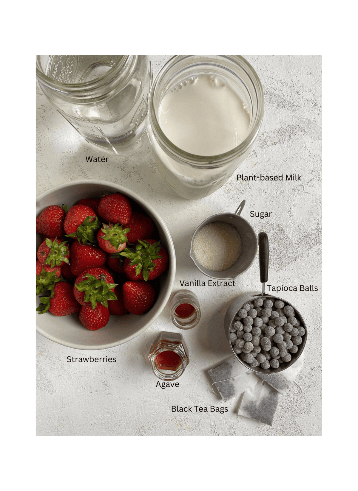 ingredients for Strawberry Boba Tea on a white surface