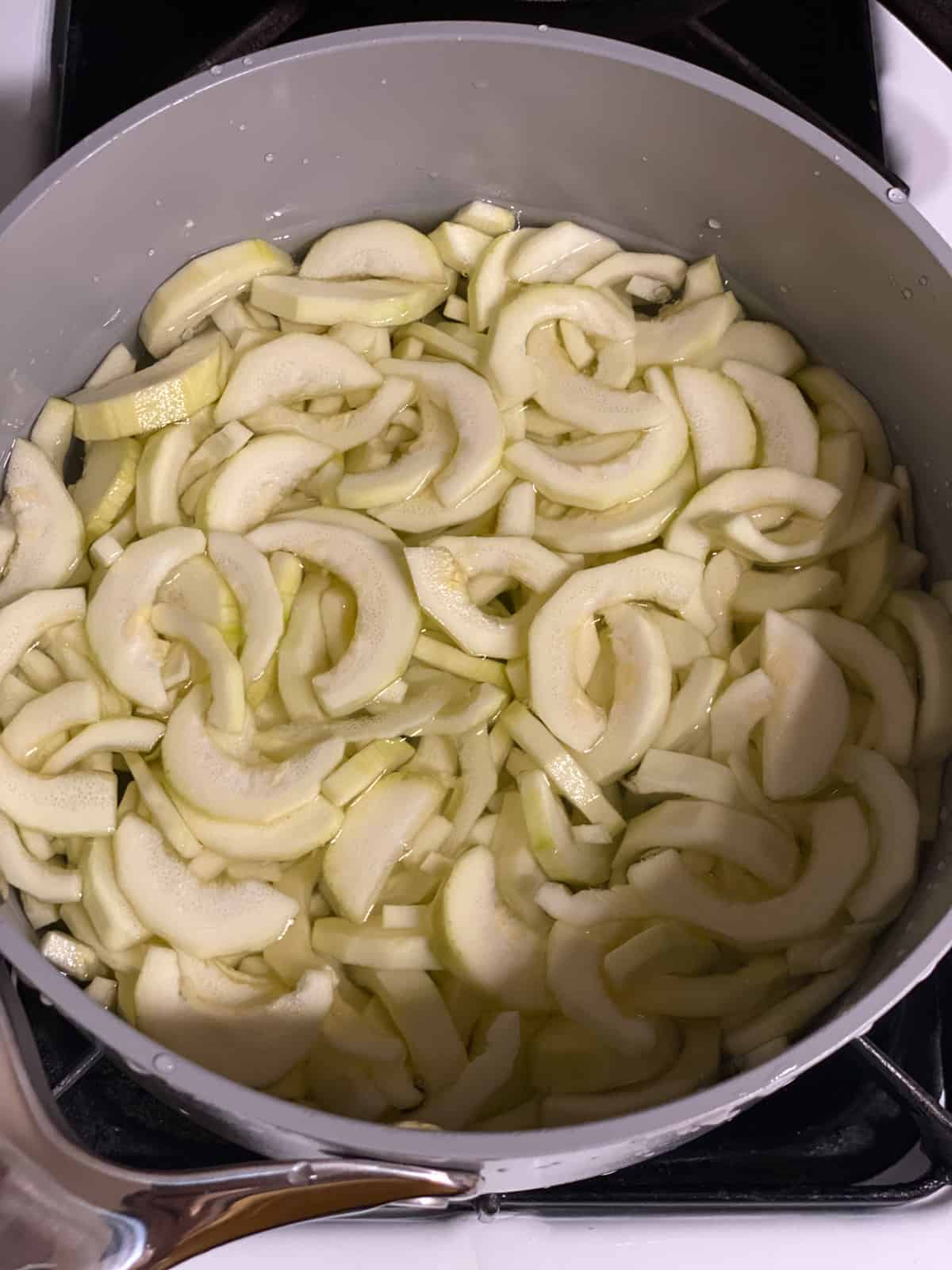 process shot of cooking zucchini in a large pot
