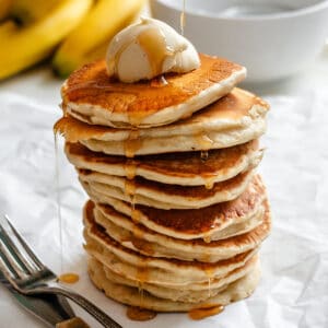 completed stack of pancakes against a white surface