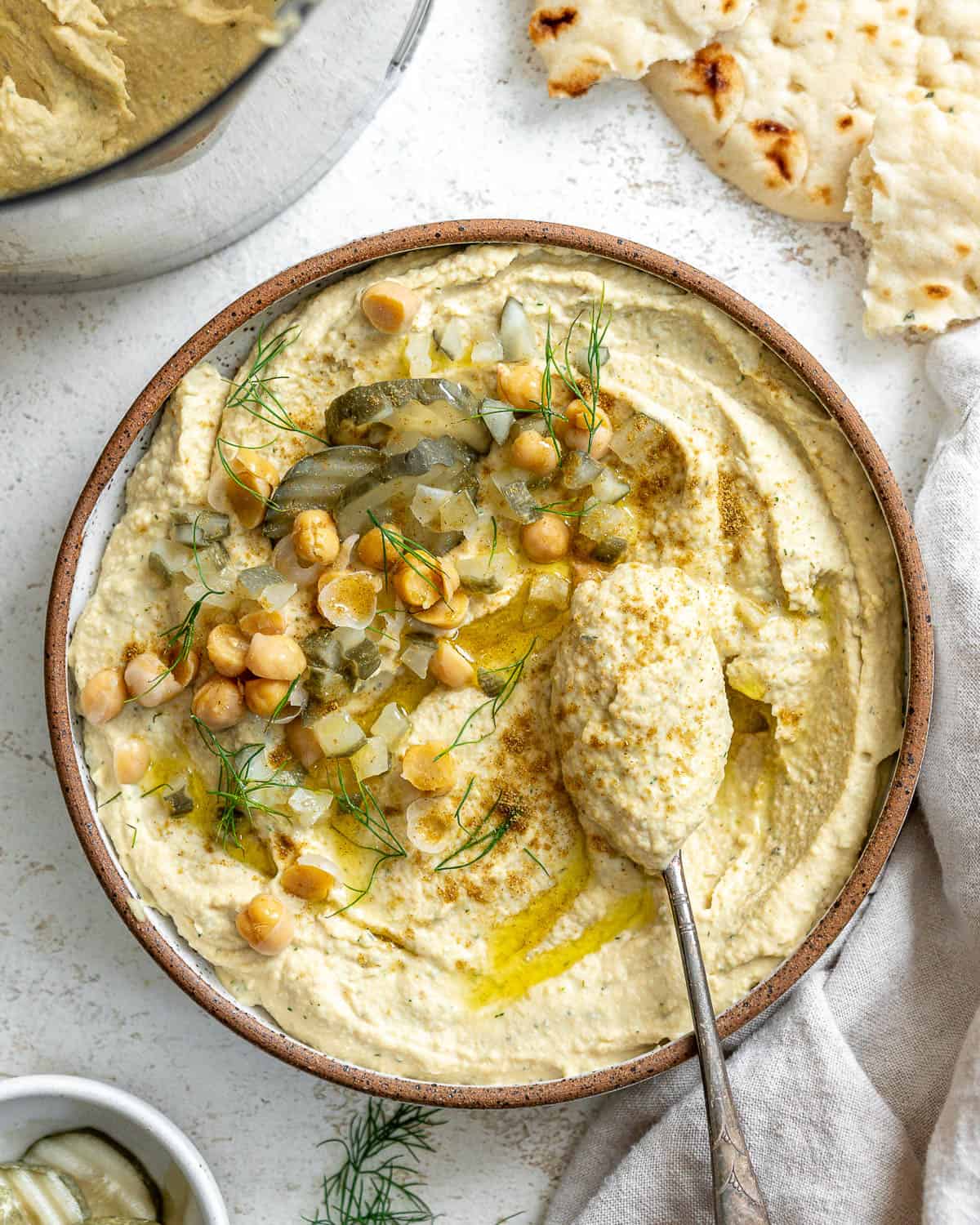 completed Dill Pickle Hummus a،nst a white background