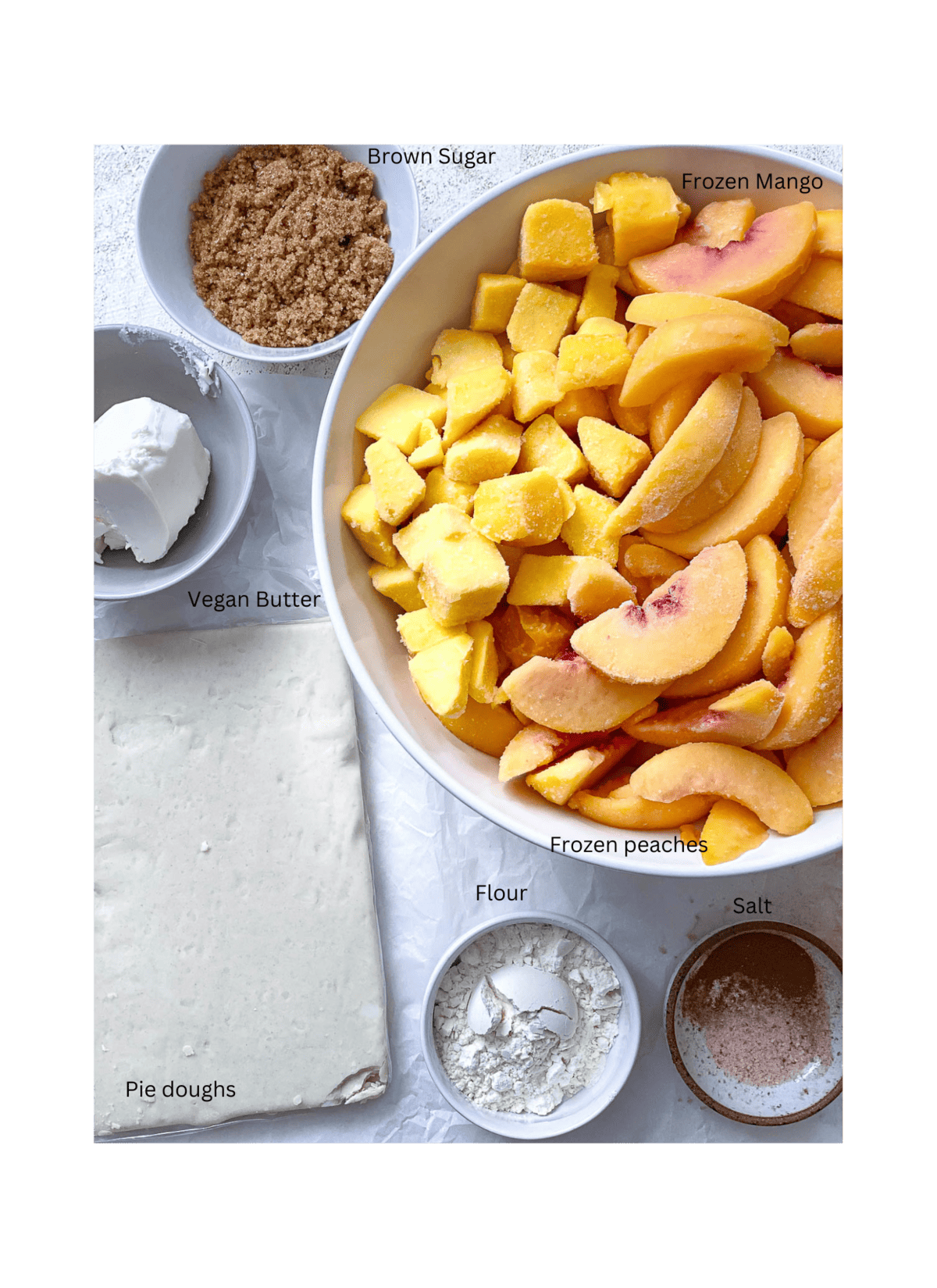 ingredients for Easy Peach Mango Pie [or Hand pies] measured out against a white surface