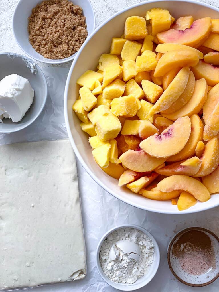 ingredients for Easy Peach Mango Pie [or Hand pies] measured out against a white surface