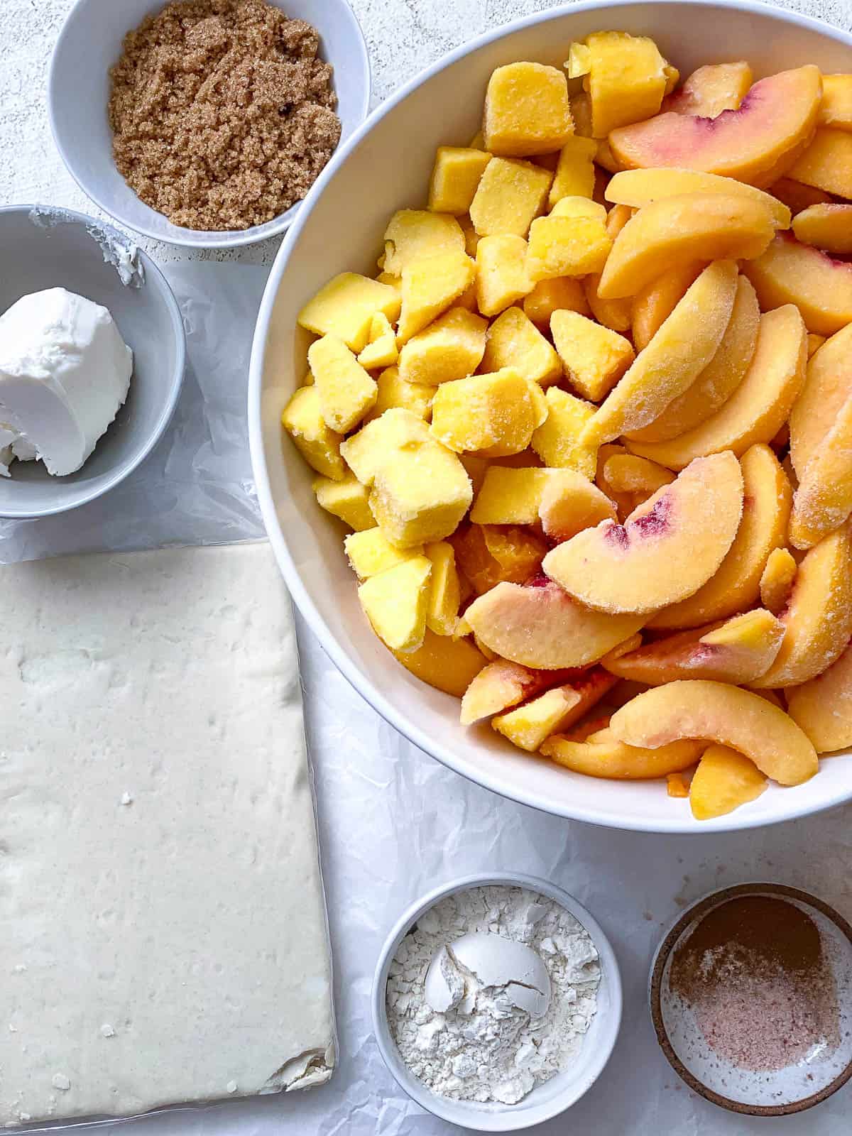 ingredients for Easy Peach Mango Pie [or Hand pies] measured out a،nst a white surface