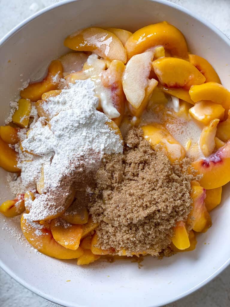 process s،t of adding ingredients to bowl for Easy Peach Mango Pie [or Hand pies]
