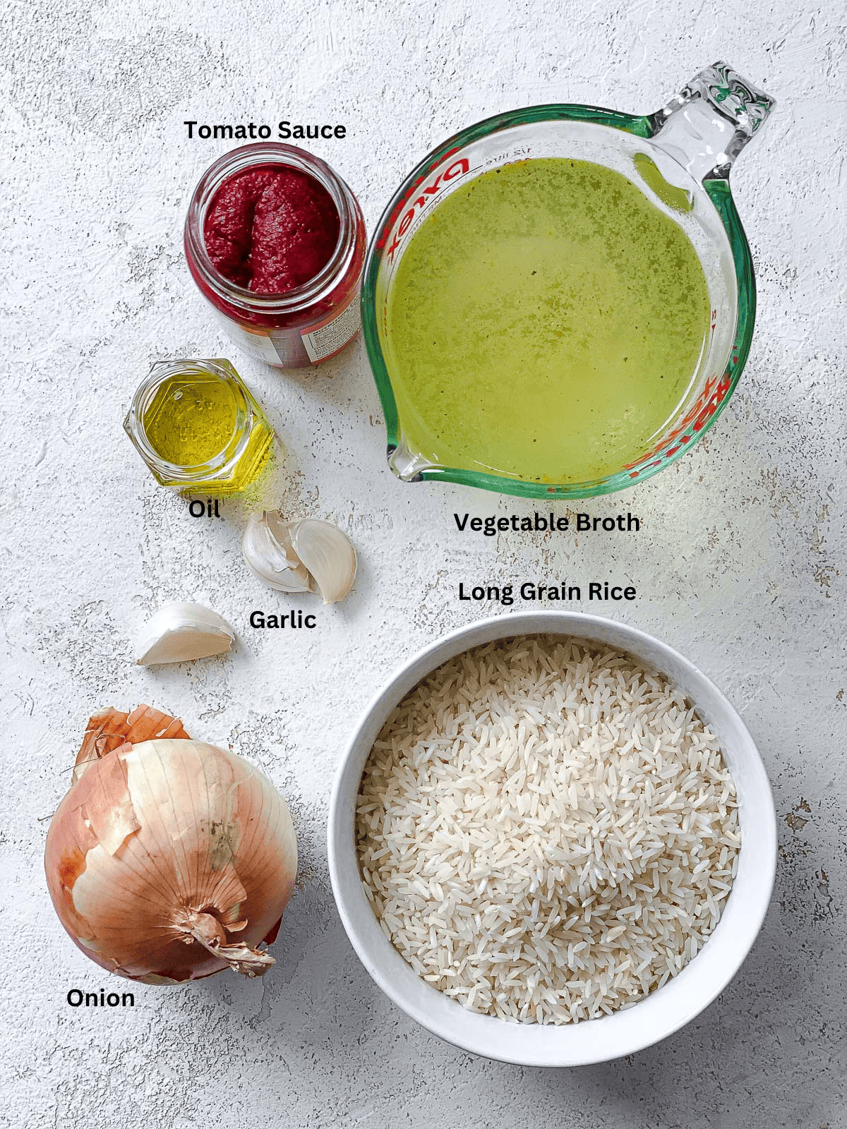 Ingredients for Vegan Mexican Rice measured out on a white surface. 