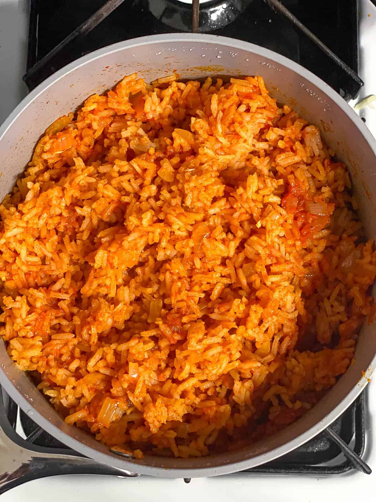 Process shot of rice being cooked in pot.