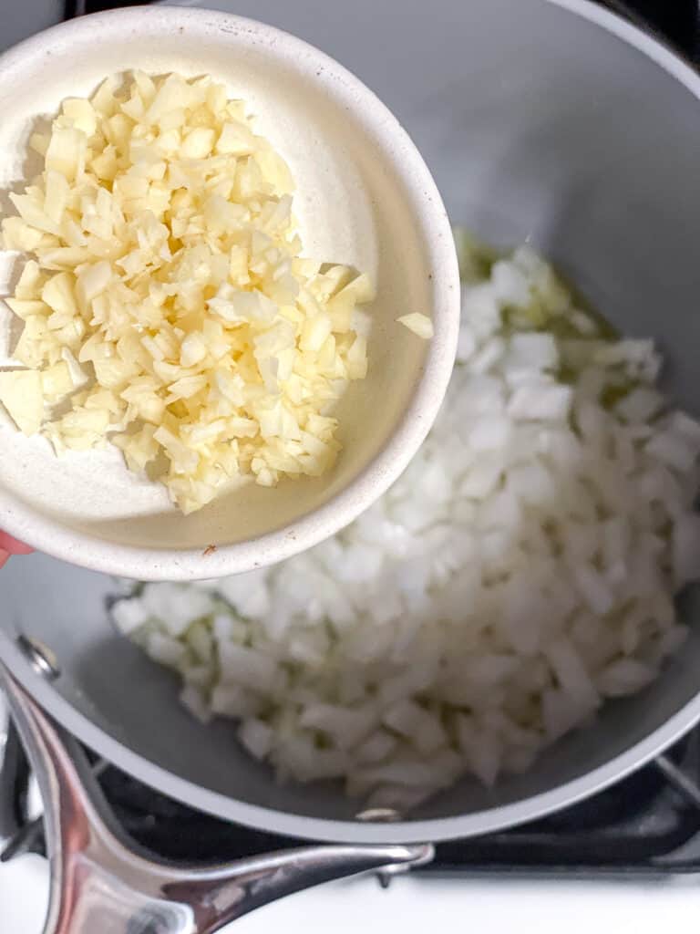 process shot of adding garlic to pot