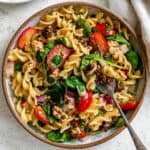 completed Sun Dried Tomato Pasta Salad against a white surface