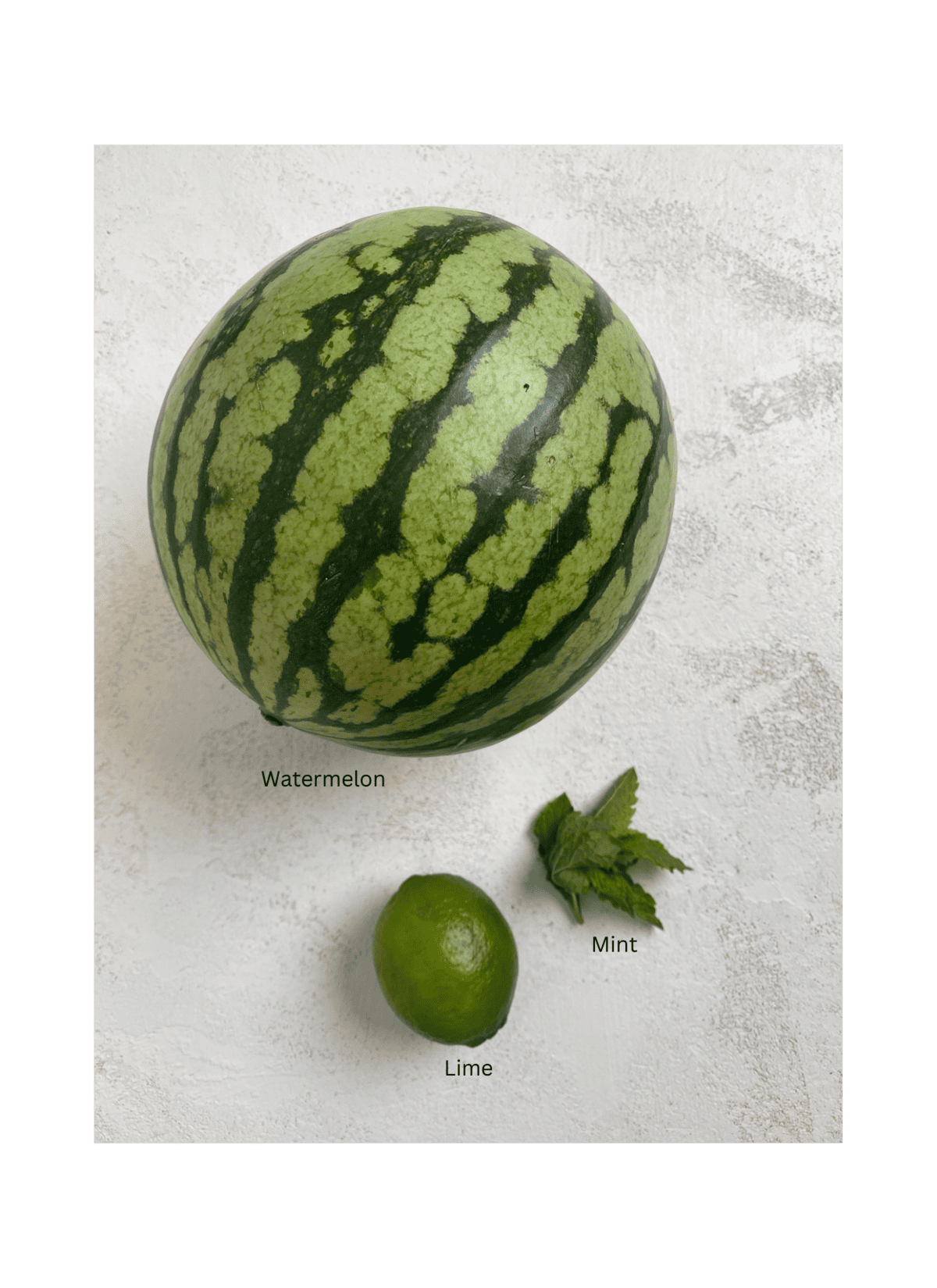 ingredients of watermelon, lime and mint on a white surface