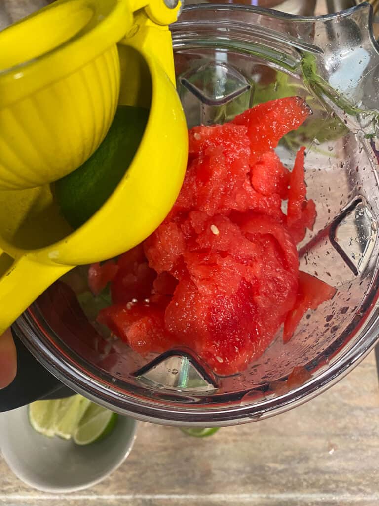 process shot of adding watermelon and lime to blender