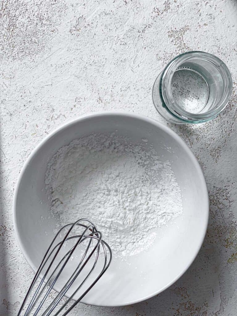 cornstarch and water in bowls against a white surface