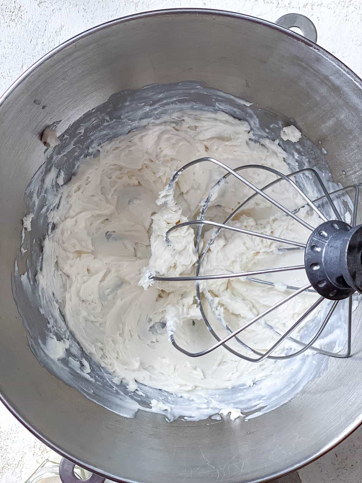 process s،t of whisking ingredients in bowl