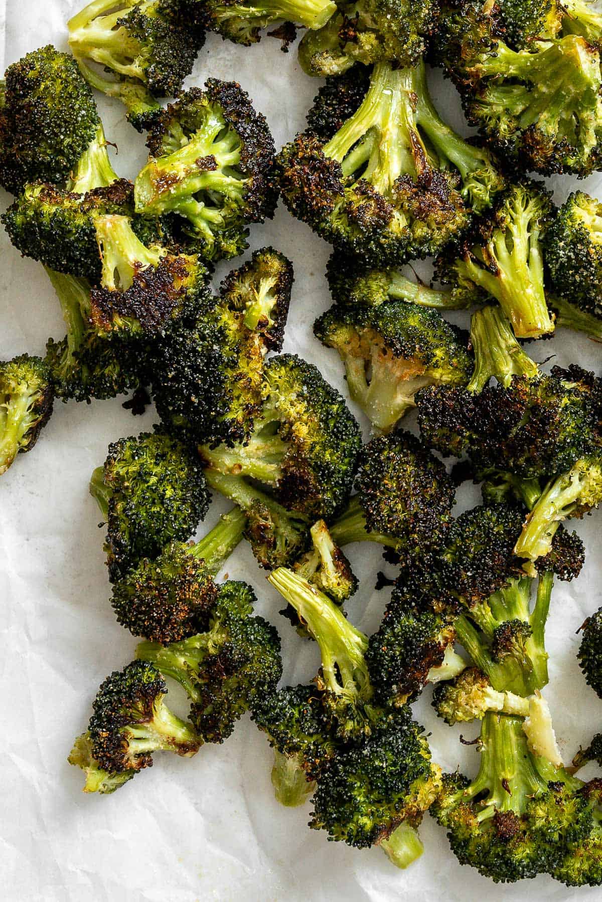 completed Oven Charred Broccoli on a white surface