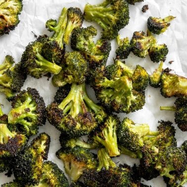 completed Oven Charred Broccoli on a white surface