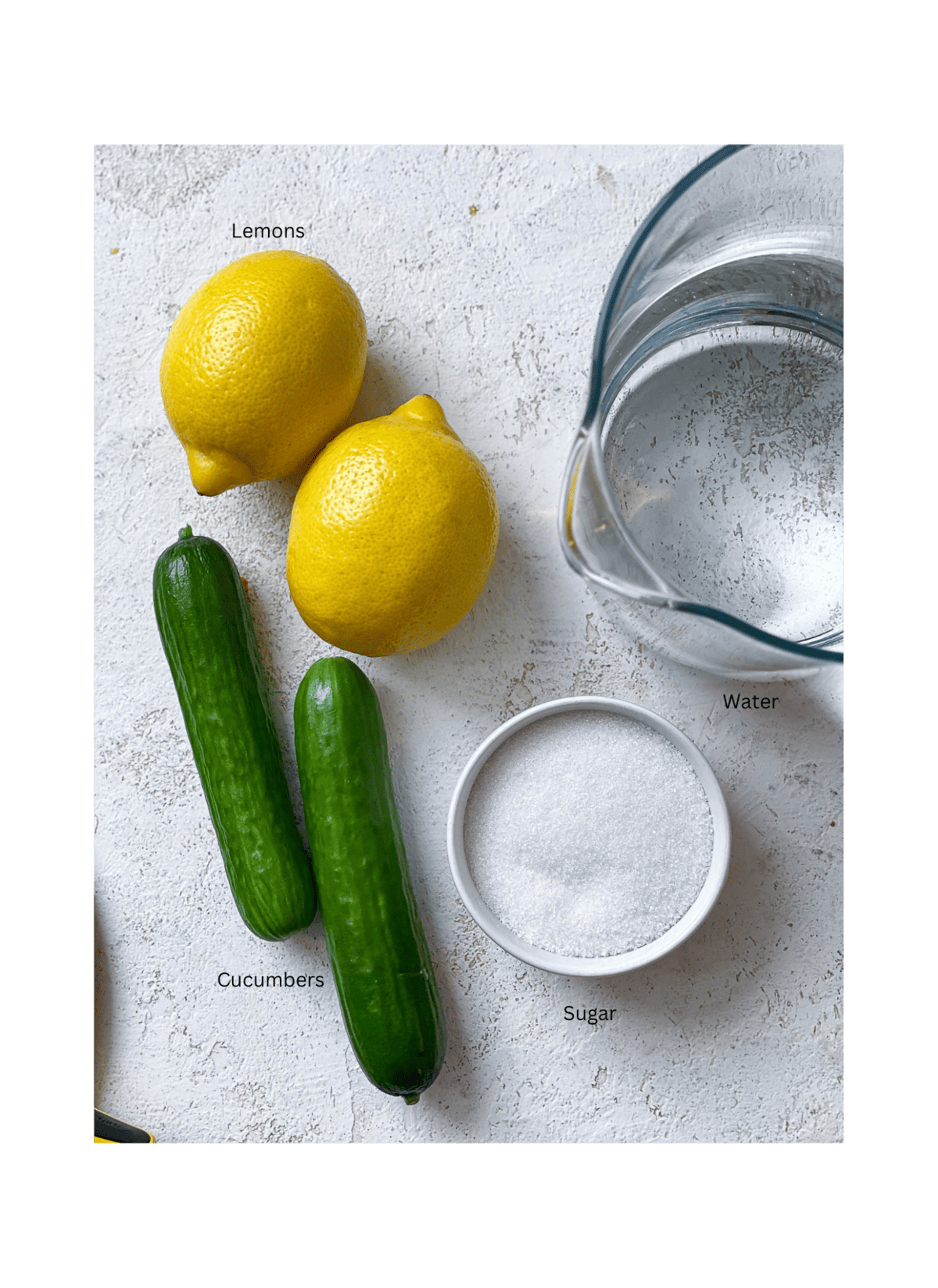 ingredients for Cucumber Lemonade against a white surface