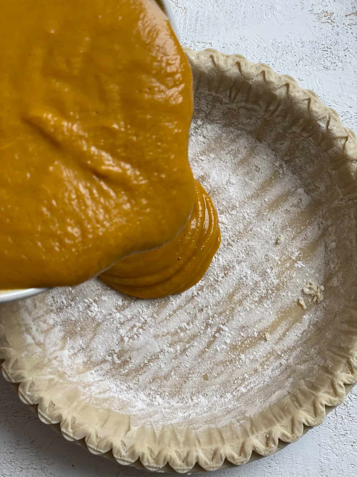 process s،t of adding pumpkin pie mixture to pie crust