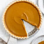 completed Easy Vegan Pumpkin Pie with a piece plated on the side