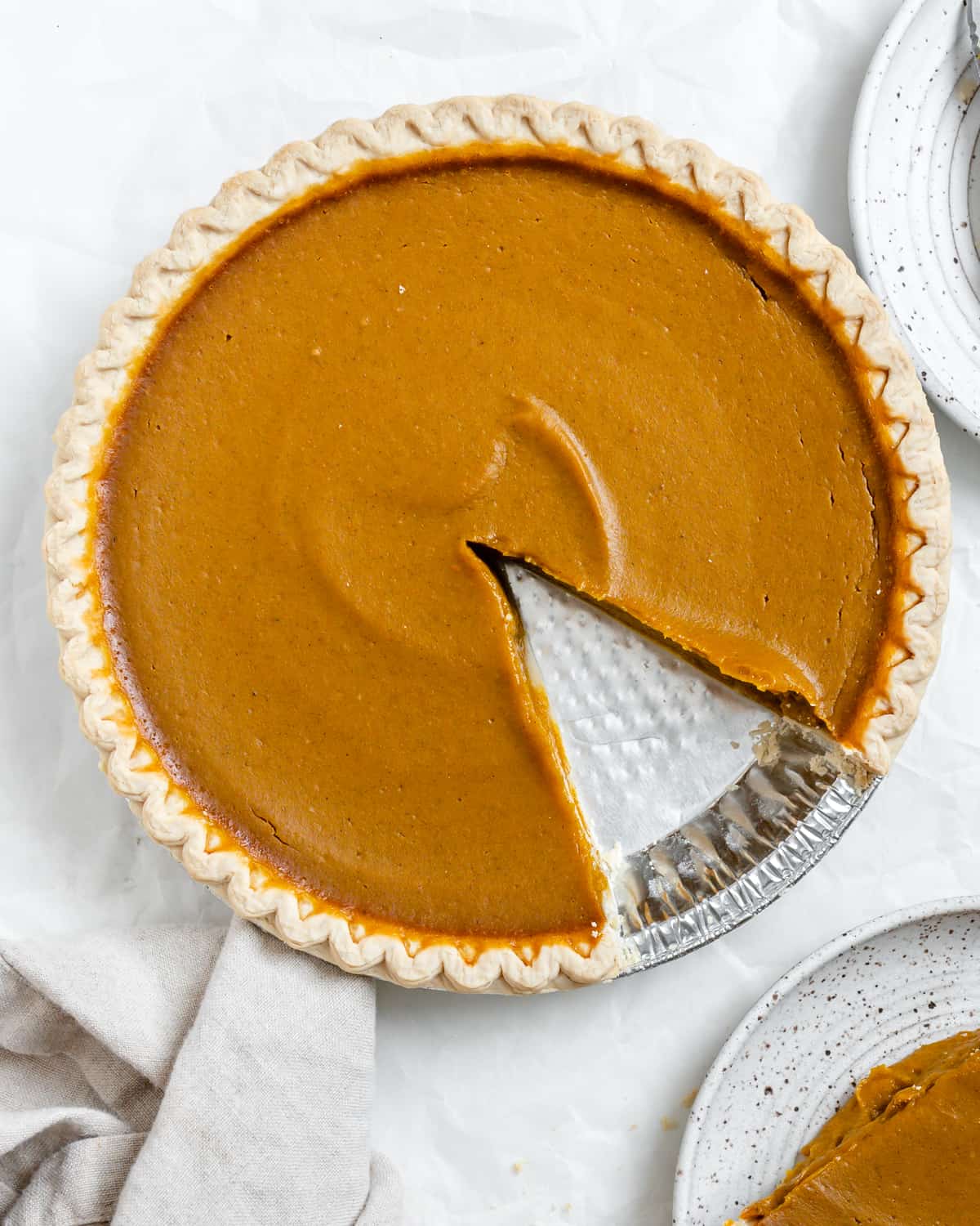 completed Easy Vegan Pumpkin Pie with a piece plated on the side