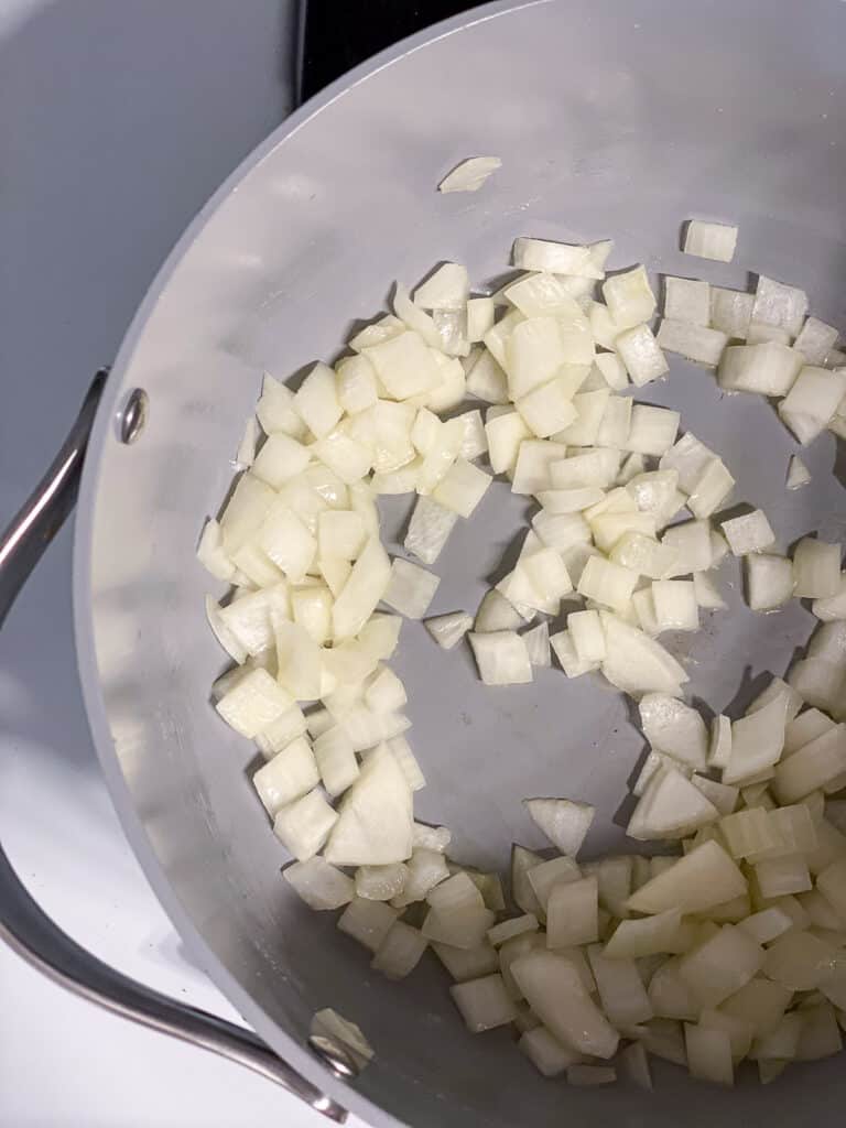 process shot of onions cooking in pan
