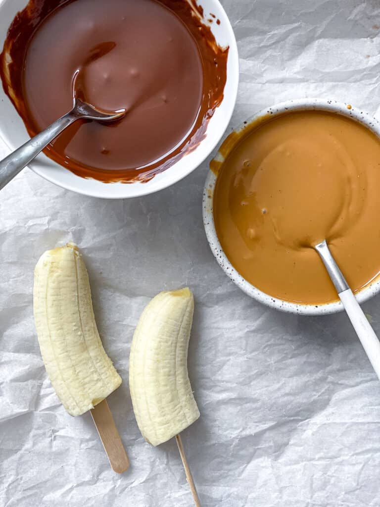ingredients for Peanut Butter and C،colate Covered Bananas on a white surface