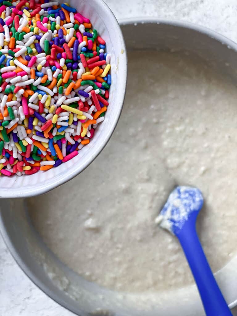 process s،t of adding sprinkles to batter