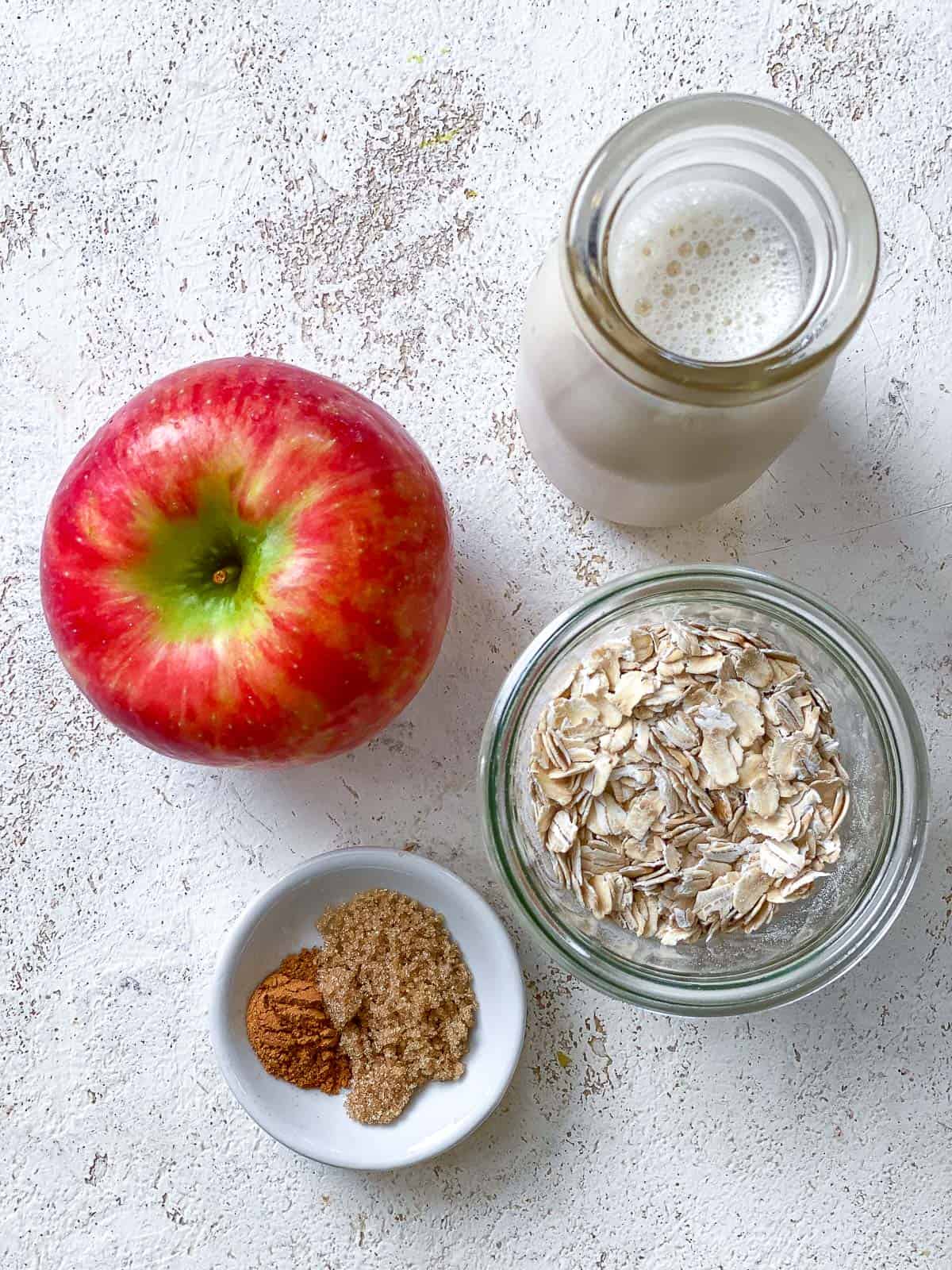 ingredients for Apple Cinnamon Overnight Oats measured out a،nst a white surface