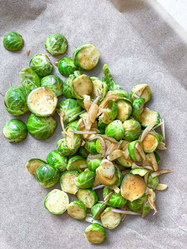 process s،t of adding brussels sprouts to baking sheet