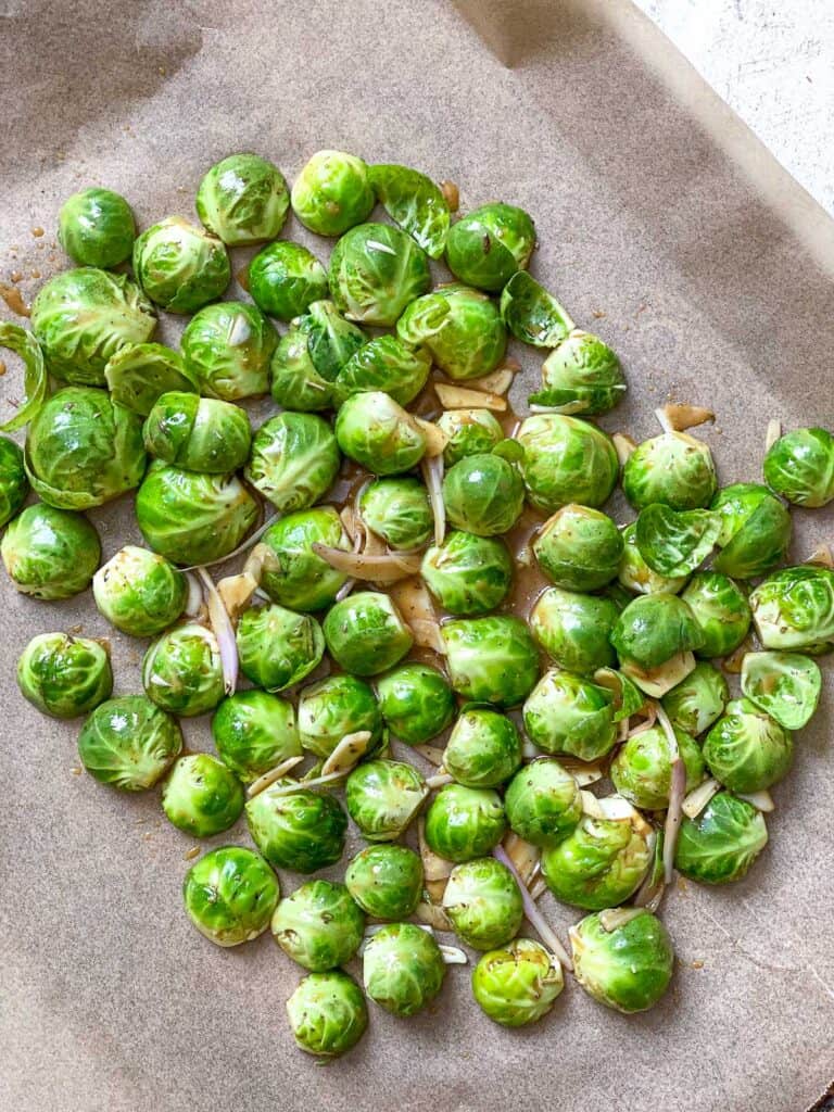 process s،t of adding brussels sprouts to baking sheet