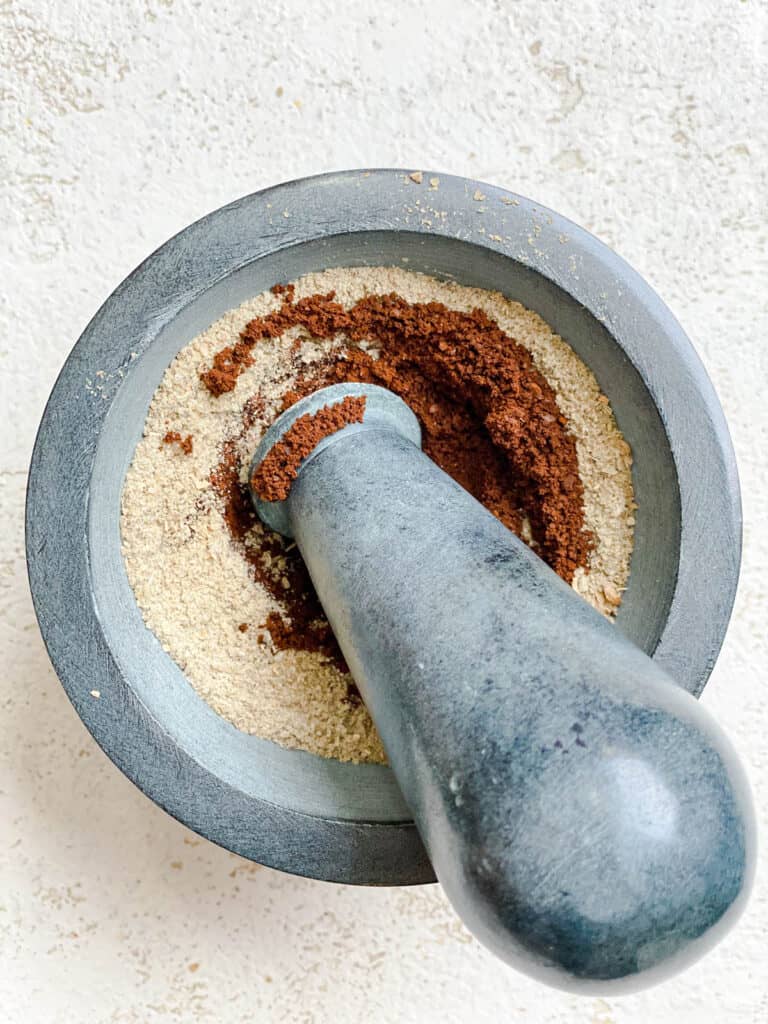 process shot of grinding coffee into spice mix