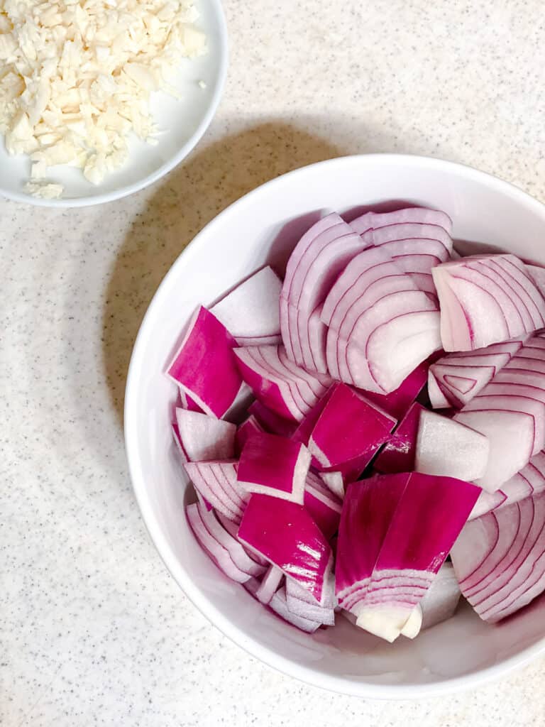 sliced onions and garlic in a bowl