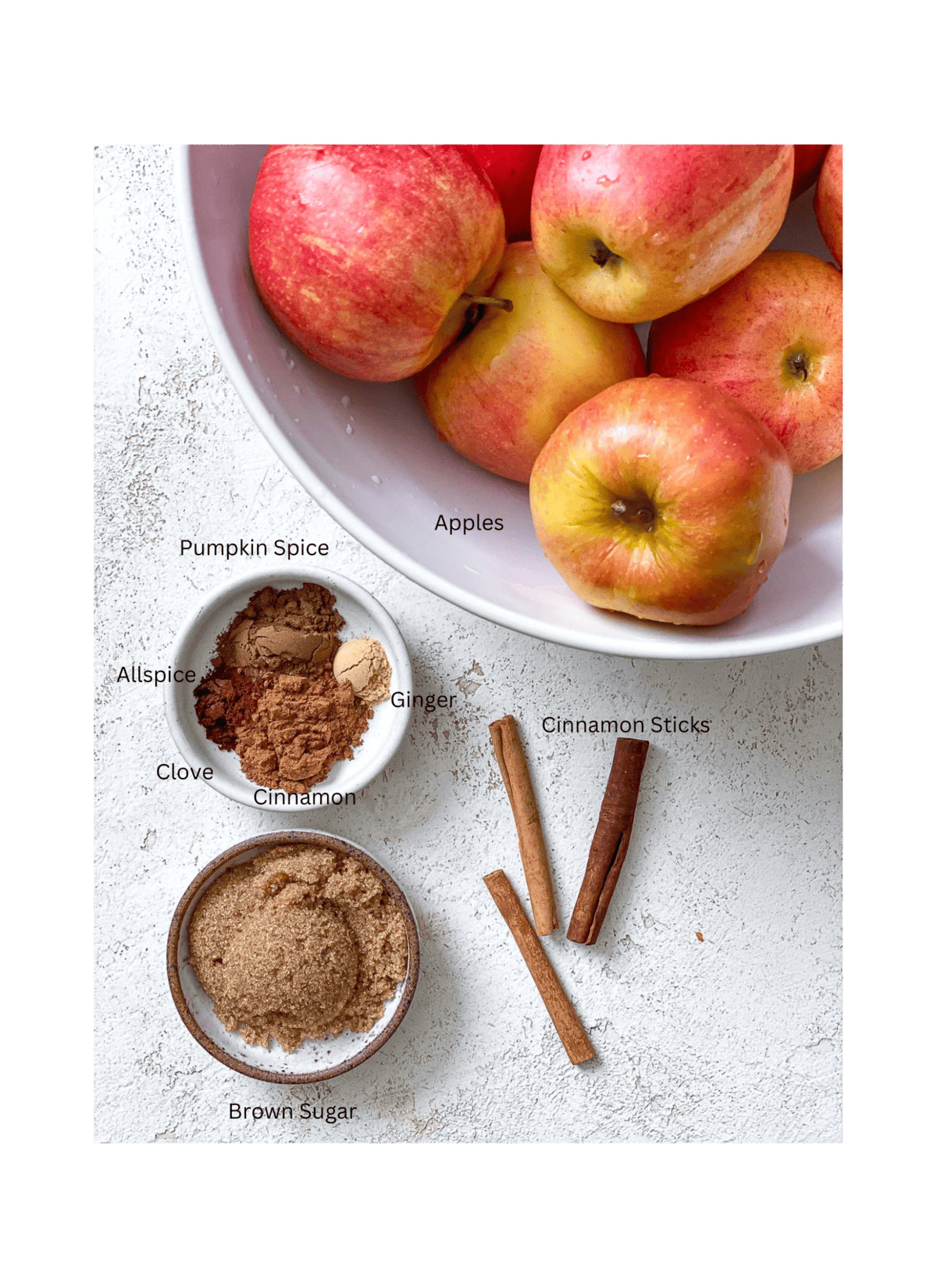 ingredients for Mulled Apple Cider against a white surface