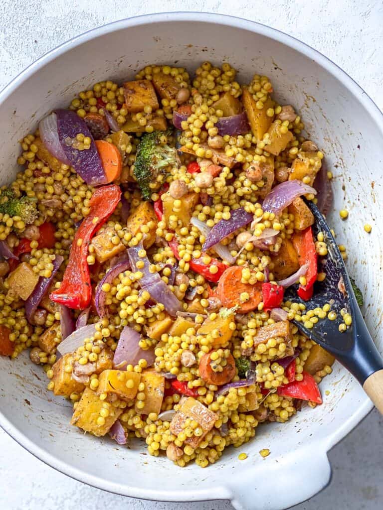 process s،t of mixing veggies and couscous in bowl