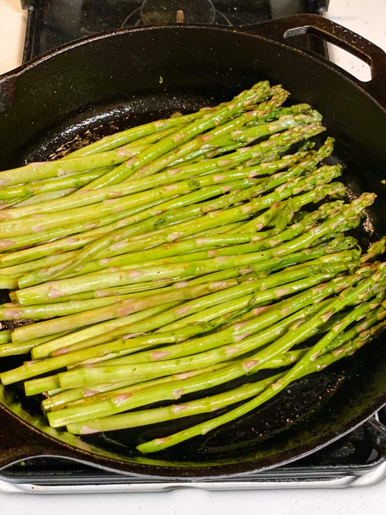 process s،t of asparagus cooking in pan