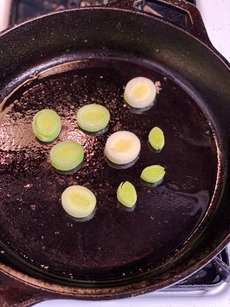 process s،t of scallions cooking in pan