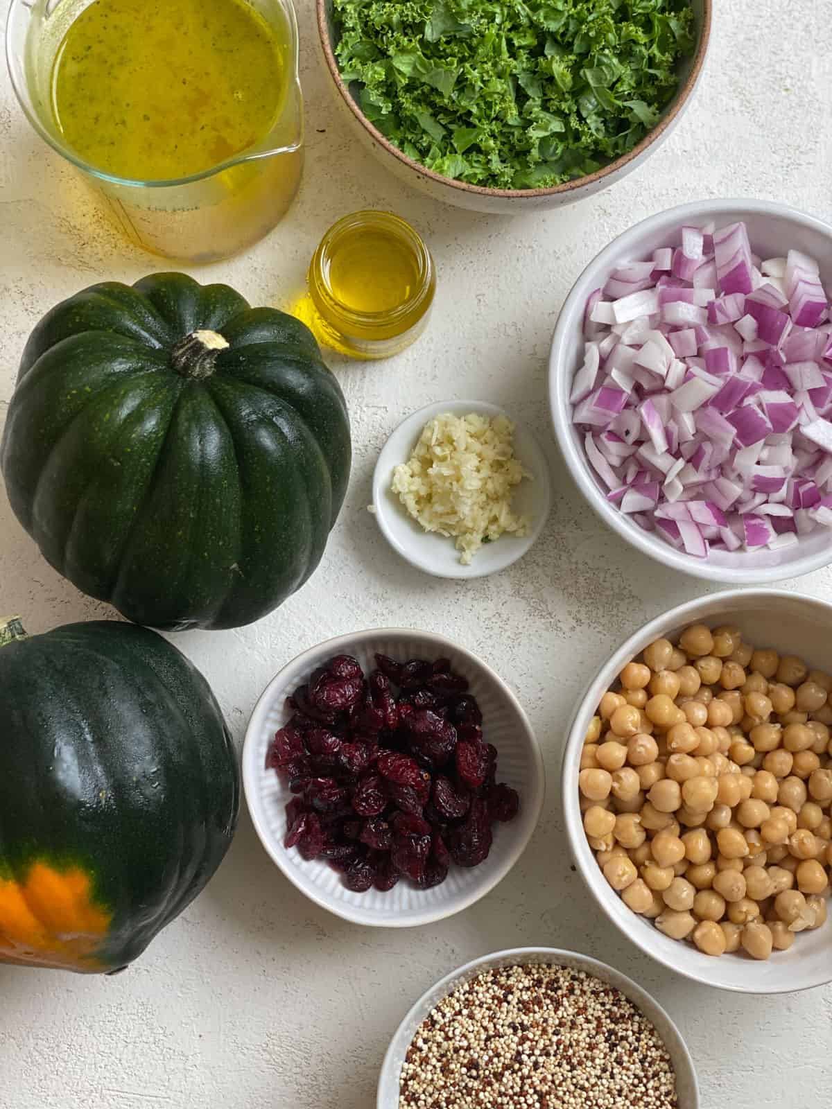 ingredients for Vegan Stuffed Acorn Squash [With Quinoa] measured out against a white surface
