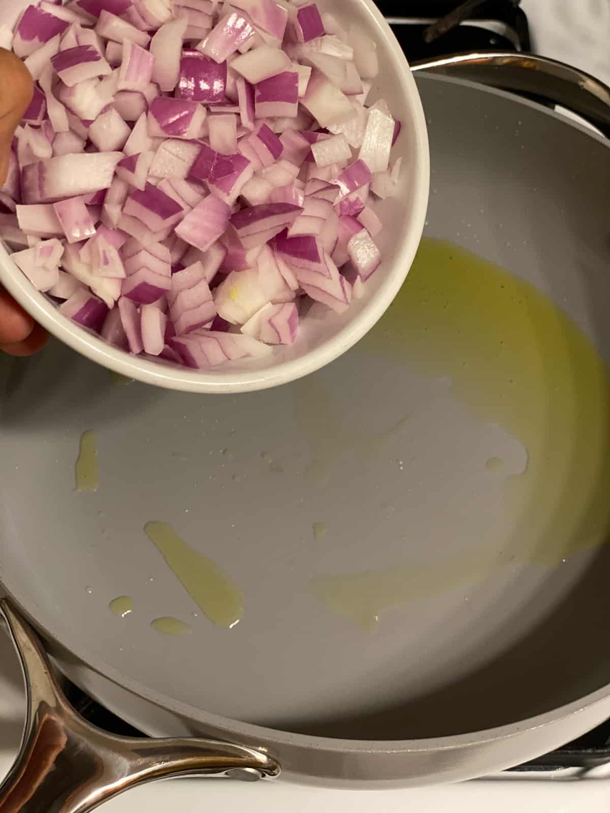 process shot of onions being added to pan