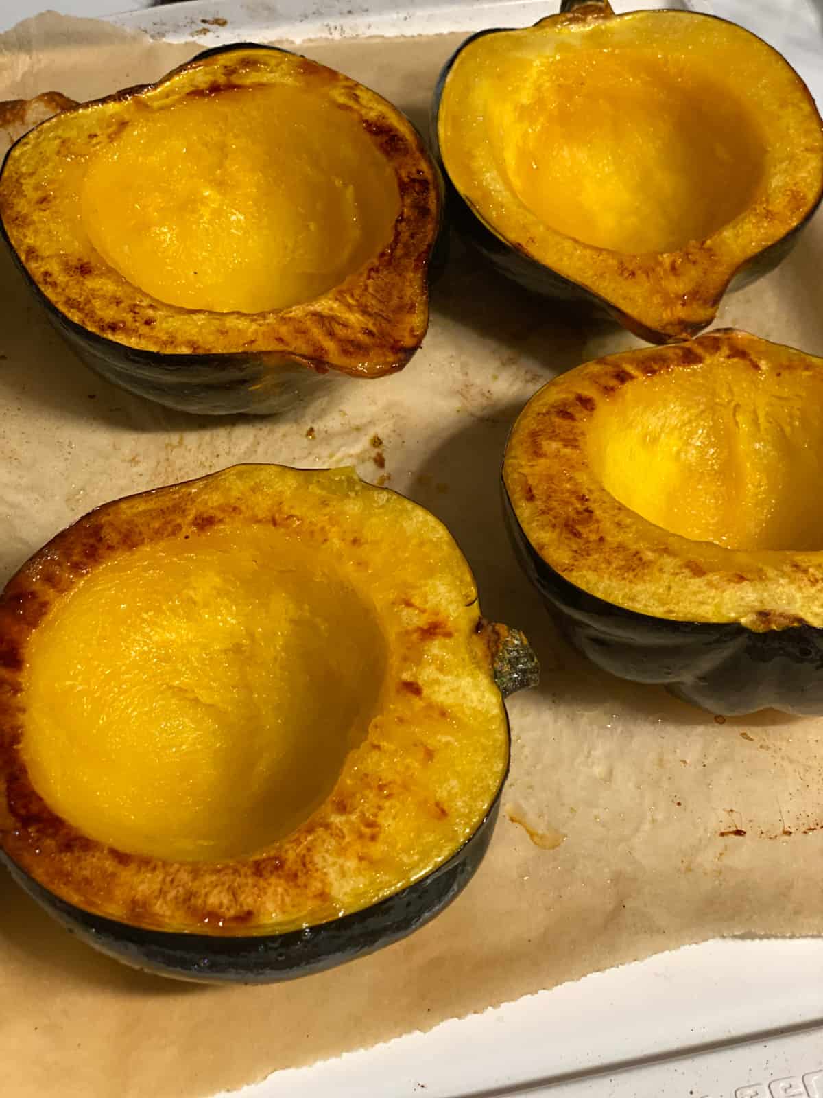 process shot showing post baked acorn squash on baking dish
